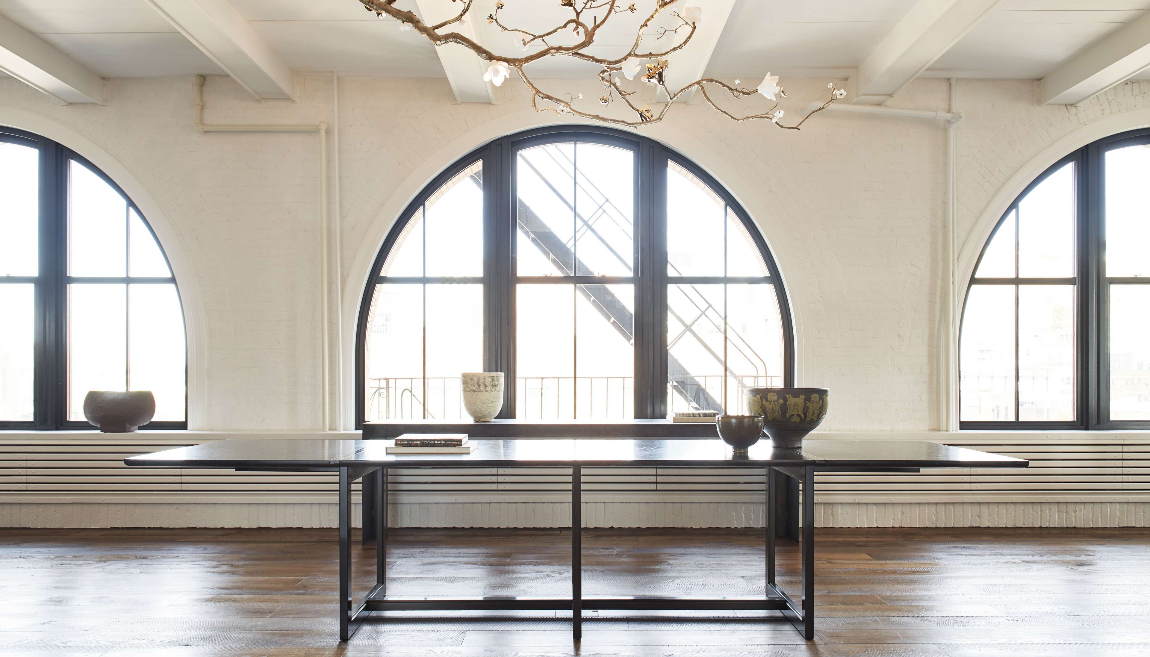 wooden-table-arched-windows.jpg